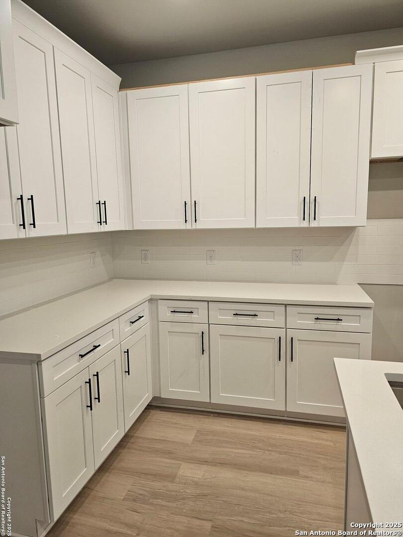 5250 Spring Branch Spring Branch, TX 78070 - Photo 6 of 23 a white kitchen with granite countertop white cabinets