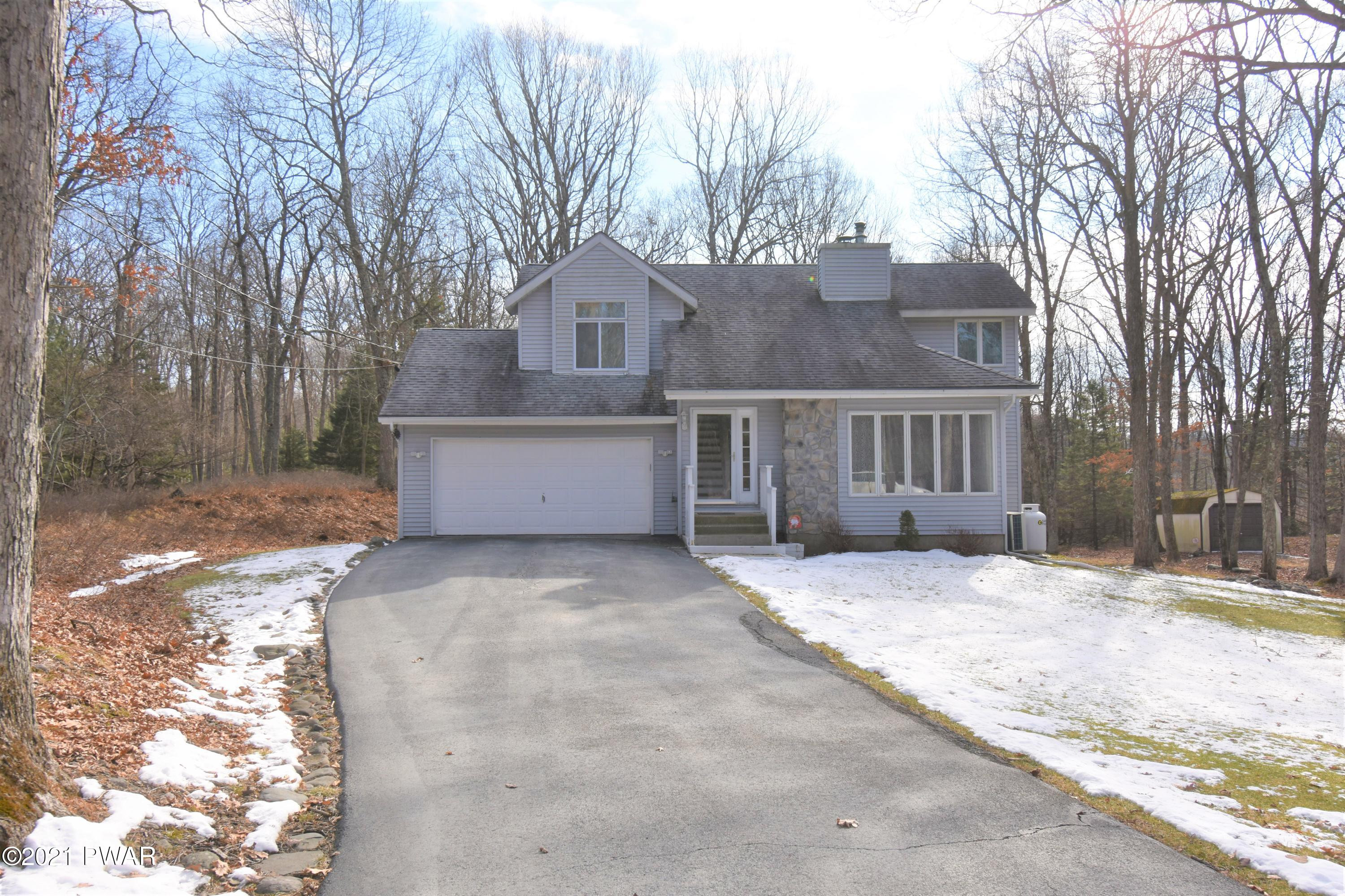 244 Fox Road Dingmans Ferry, PA 18328 - Photo 1 of 31 a front view of a house with a yard and garage