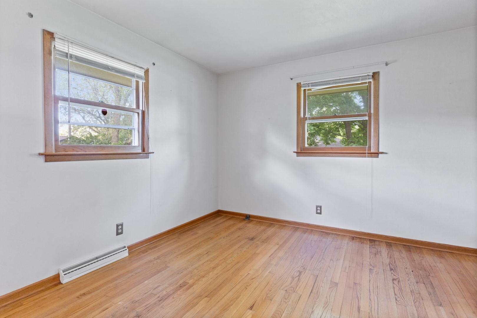 5864 Dover Road Rockford, IL 61109 - Photo 18 of 33 a view of an empty room with wooden floor and a window