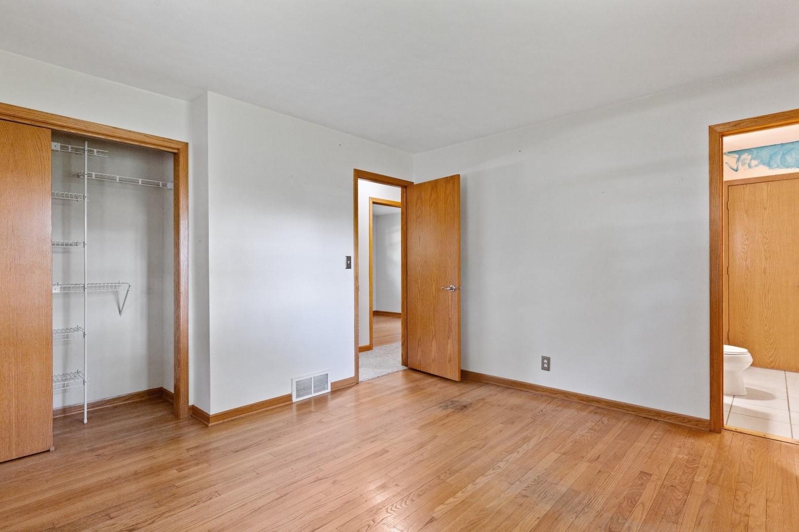 5864 Dover Road Rockford, IL 61109 - Photo 19 of 33 an empty room with wooden floor and closet
