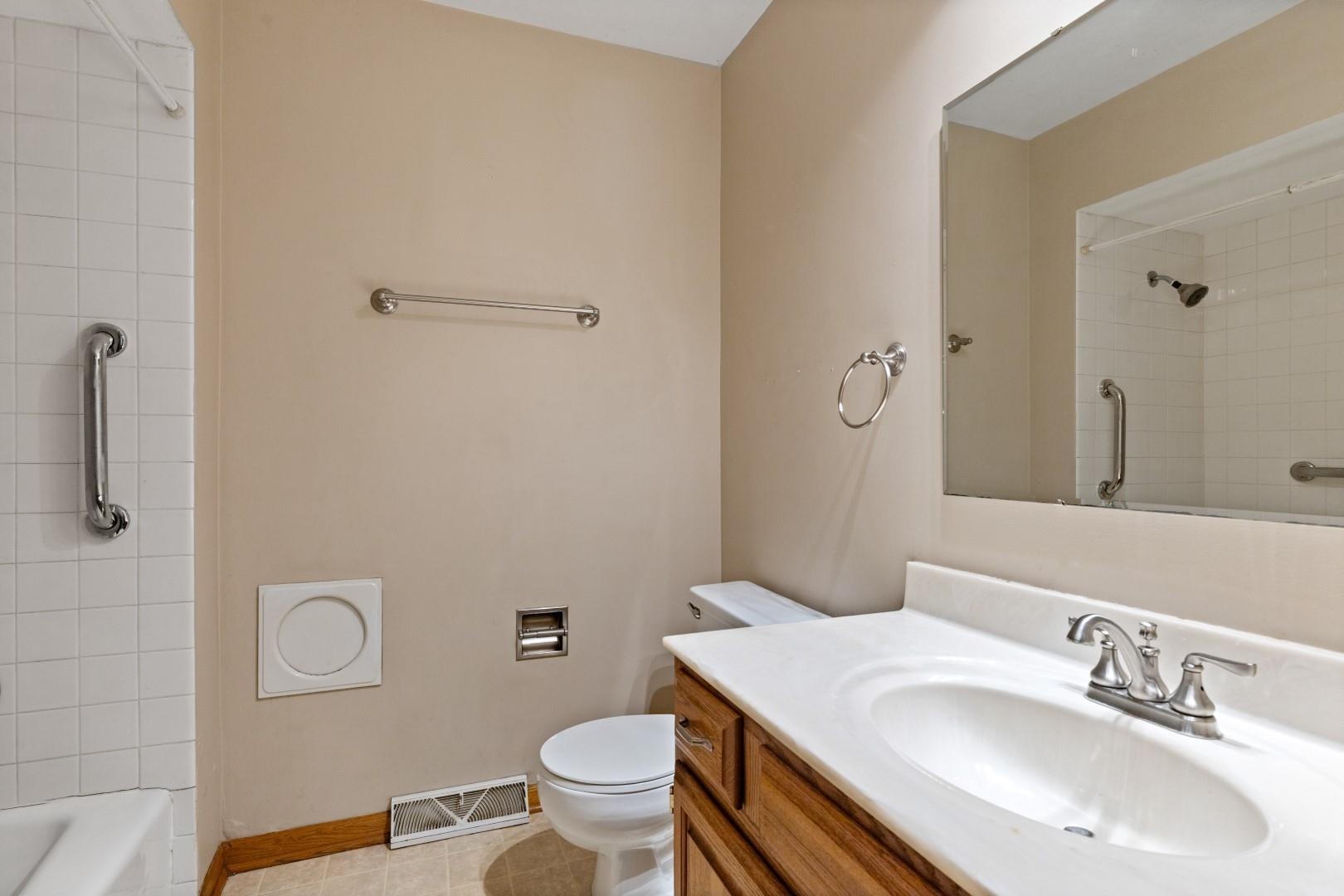 5864 Dover Road Rockford, IL 61109 - Photo 22 of 33 a bathroom with a sink toilet and vanity