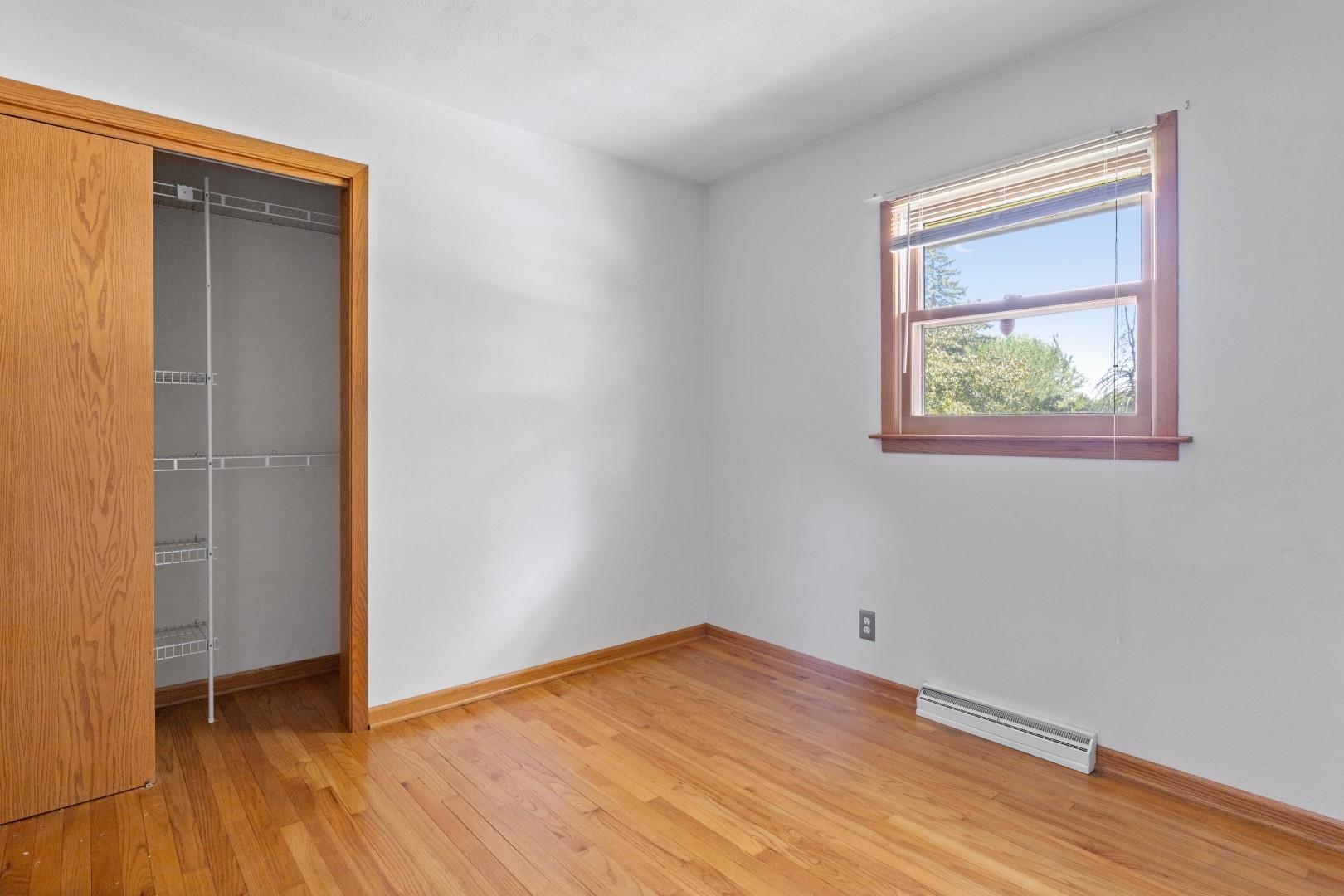 5864 Dover Road Rockford, IL 61109 - Photo 23 of 33 an empty room with wooden floor and closet