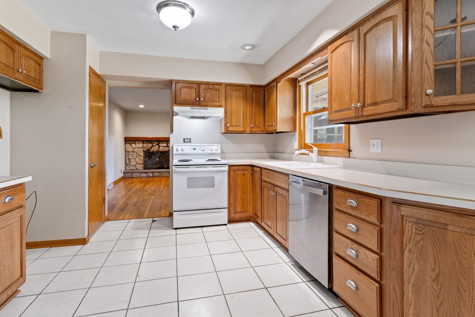 5864 Dover Road Rockford, IL 61109 - Photo 4 of 33 a kitchen with stainless steel appliances granite countertop a stove a sink and a microwave