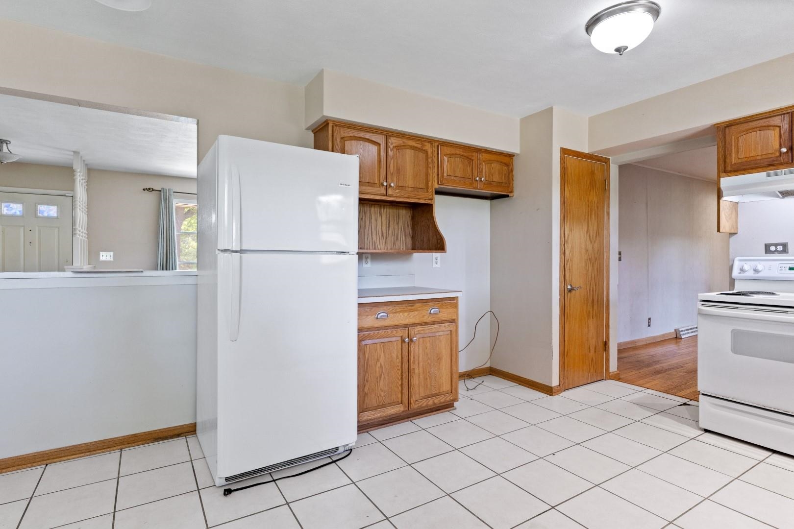 5864 Dover Road Rockford, IL 61109 - Photo 5 of 33 a white refrigerator freezer and a stove sitting inside of a kitchen