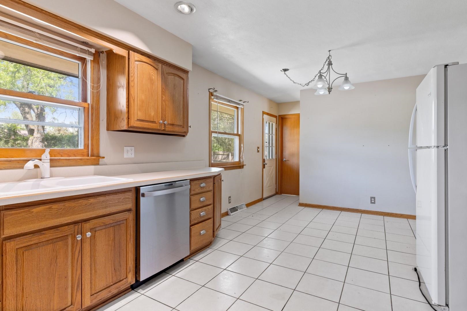 5864 Dover Road Rockford, IL 61109 - Photo 6 of 33 a kitchen with stainless steel appliances granite countertop a refrigerator and a sink