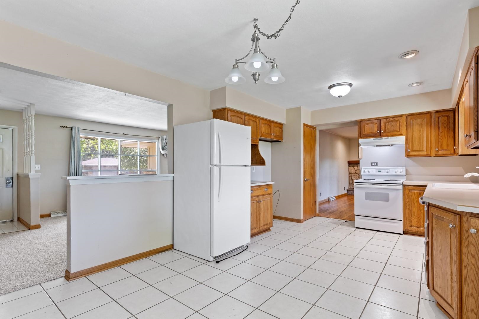 5864 Dover Road Rockford, IL 61109 - Photo 7 of 33 a kitchen with a refrigerator a stove top oven a sink and dishwasher