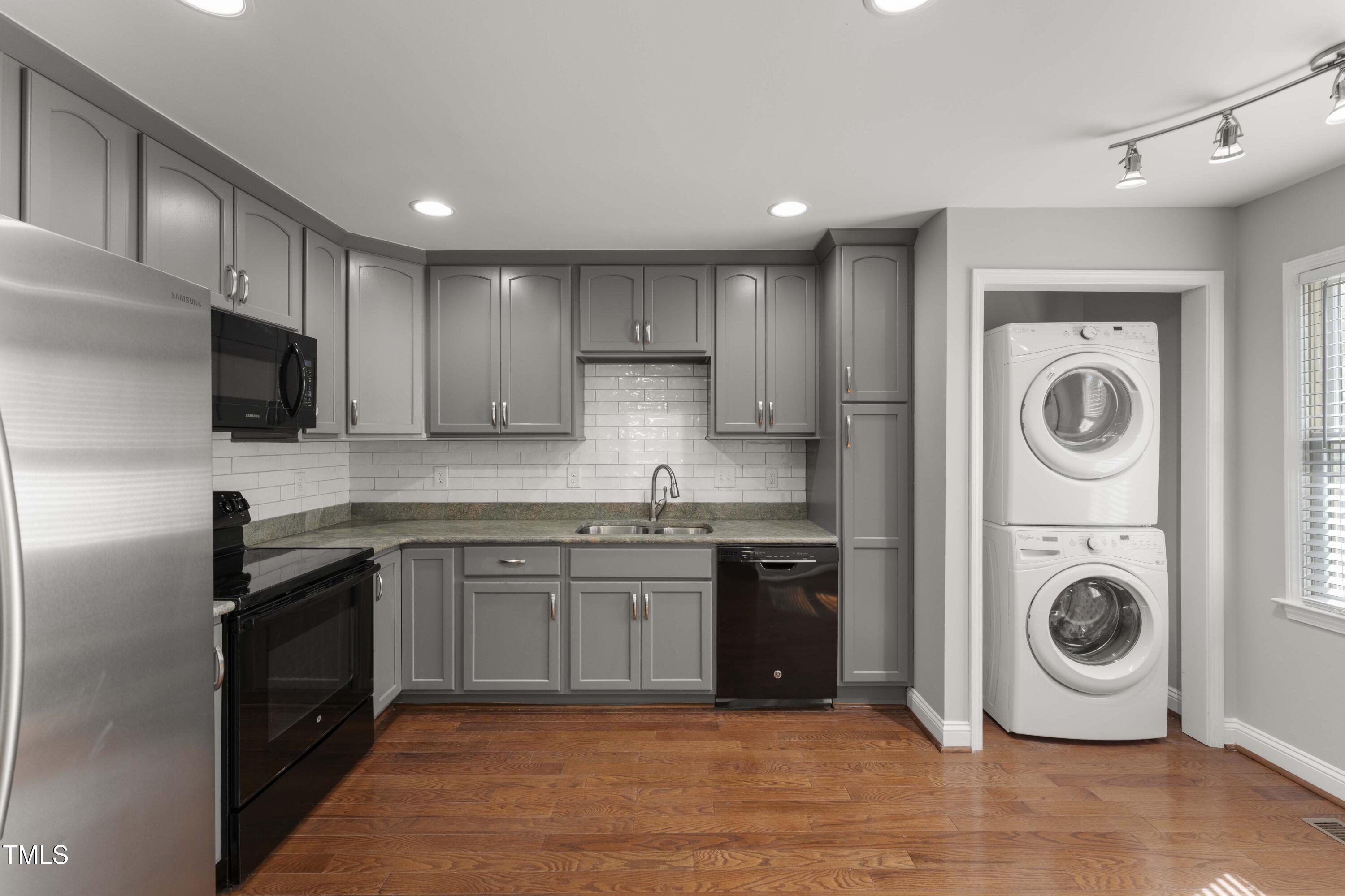 1426 Quarter Point Raleigh, NC 27615 - Photo 11 of 64 a kitchen with a sink a stove top oven and cabinets