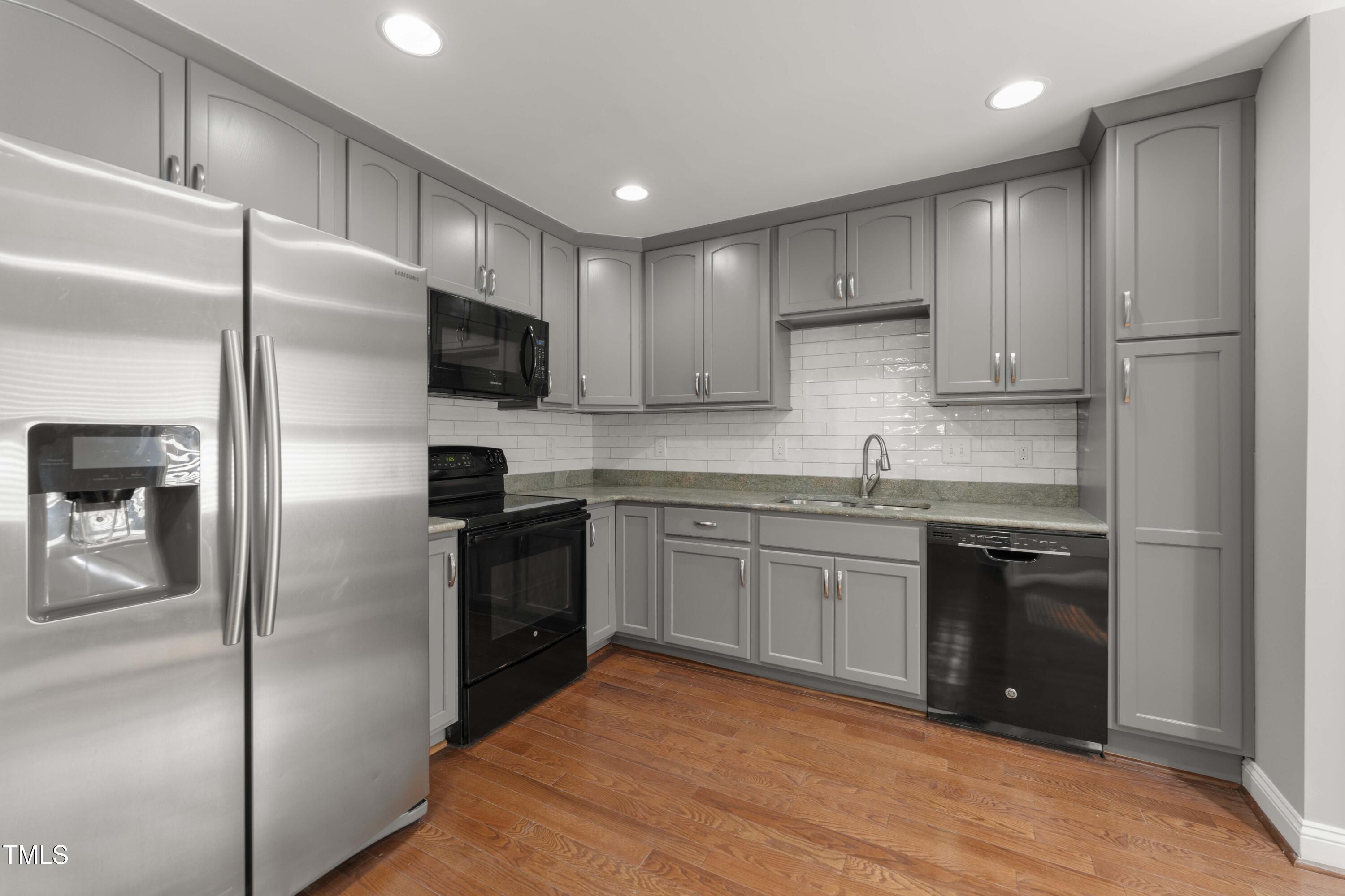 1426 Quarter Point Raleigh, NC 27615 - Photo 19 of 64 a kitchen with granite countertop stainless steel appliances and refrigerator