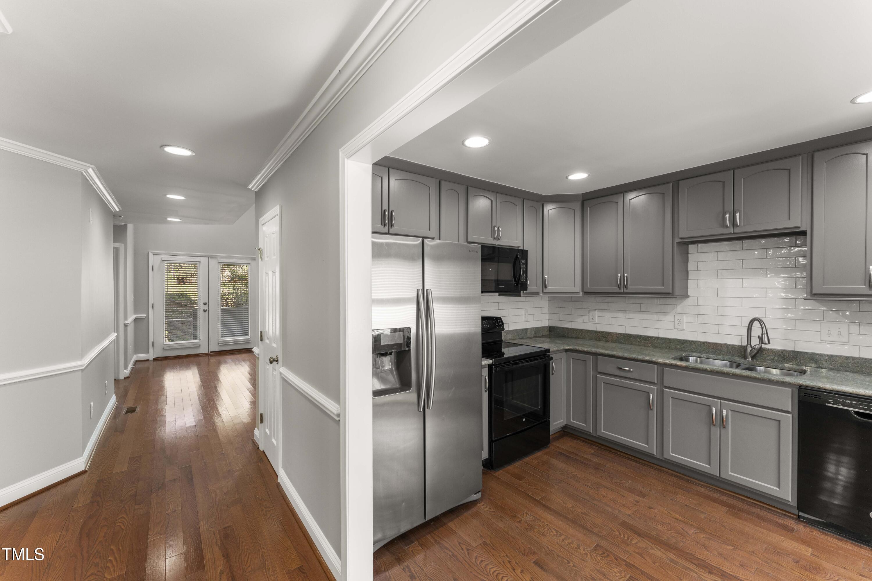 1426 Quarter Point Raleigh, NC 27615 - Photo 22 of 64 a kitchen with stainless steel appliances granite countertop a refrigerator a sink dishwasher a stove and white countertops with wooden floor