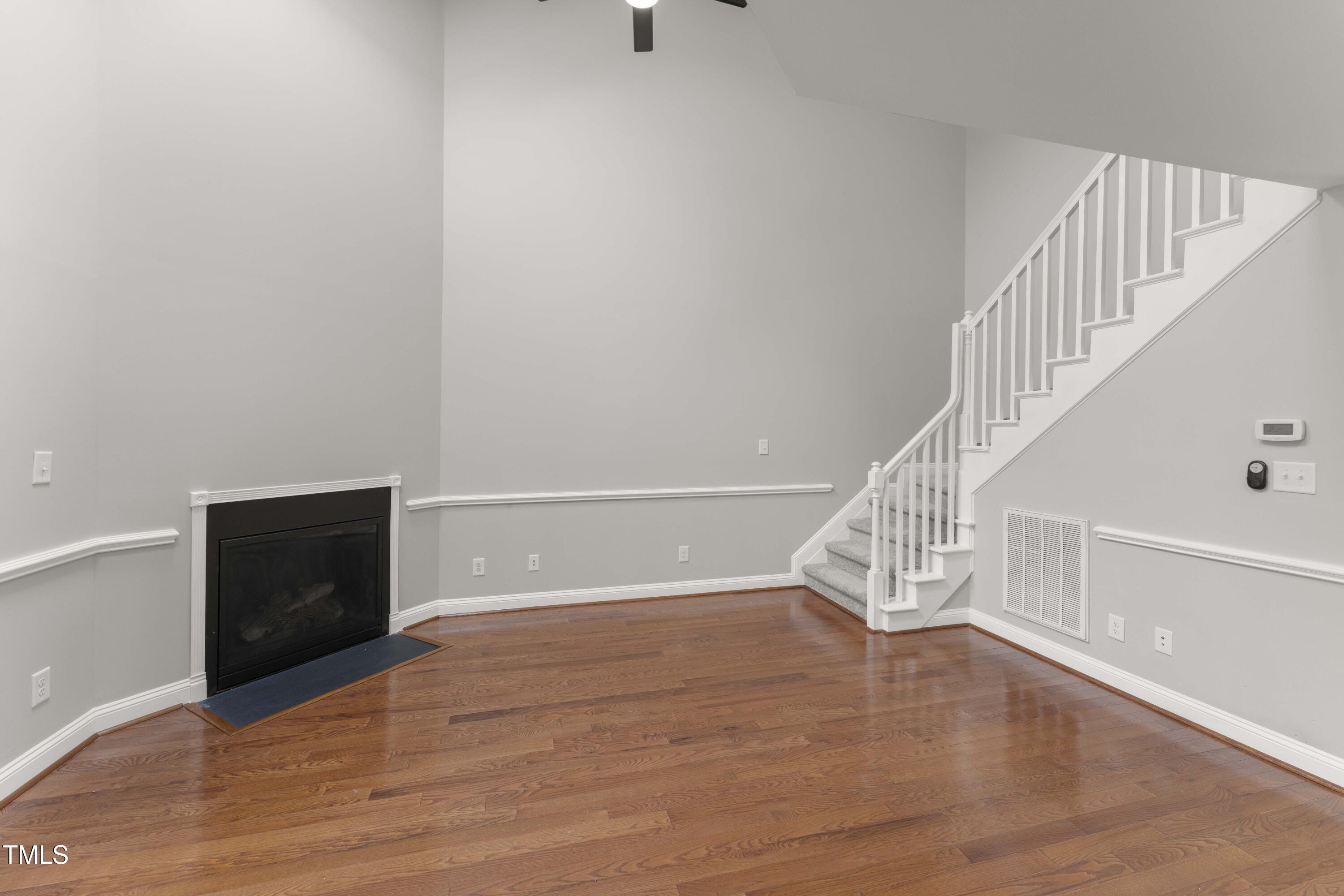 1426 Quarter Point Raleigh, NC 27615 - Photo 31 of 64 a view of an empty room with wooden floor and a window