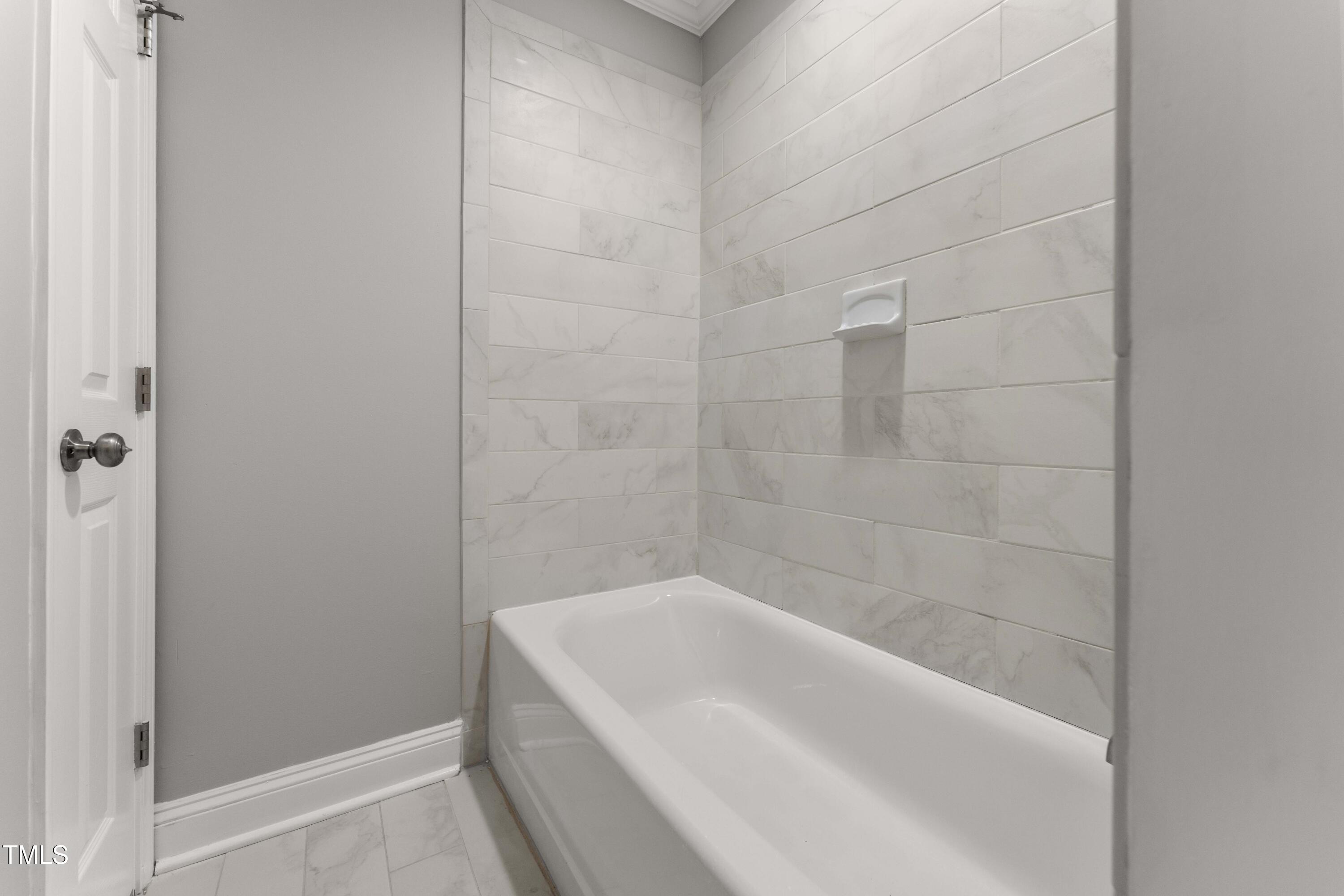 1426 Quarter Point Raleigh, NC 27615 - Photo 37 of 64 a bath tub sitting next to a white sink