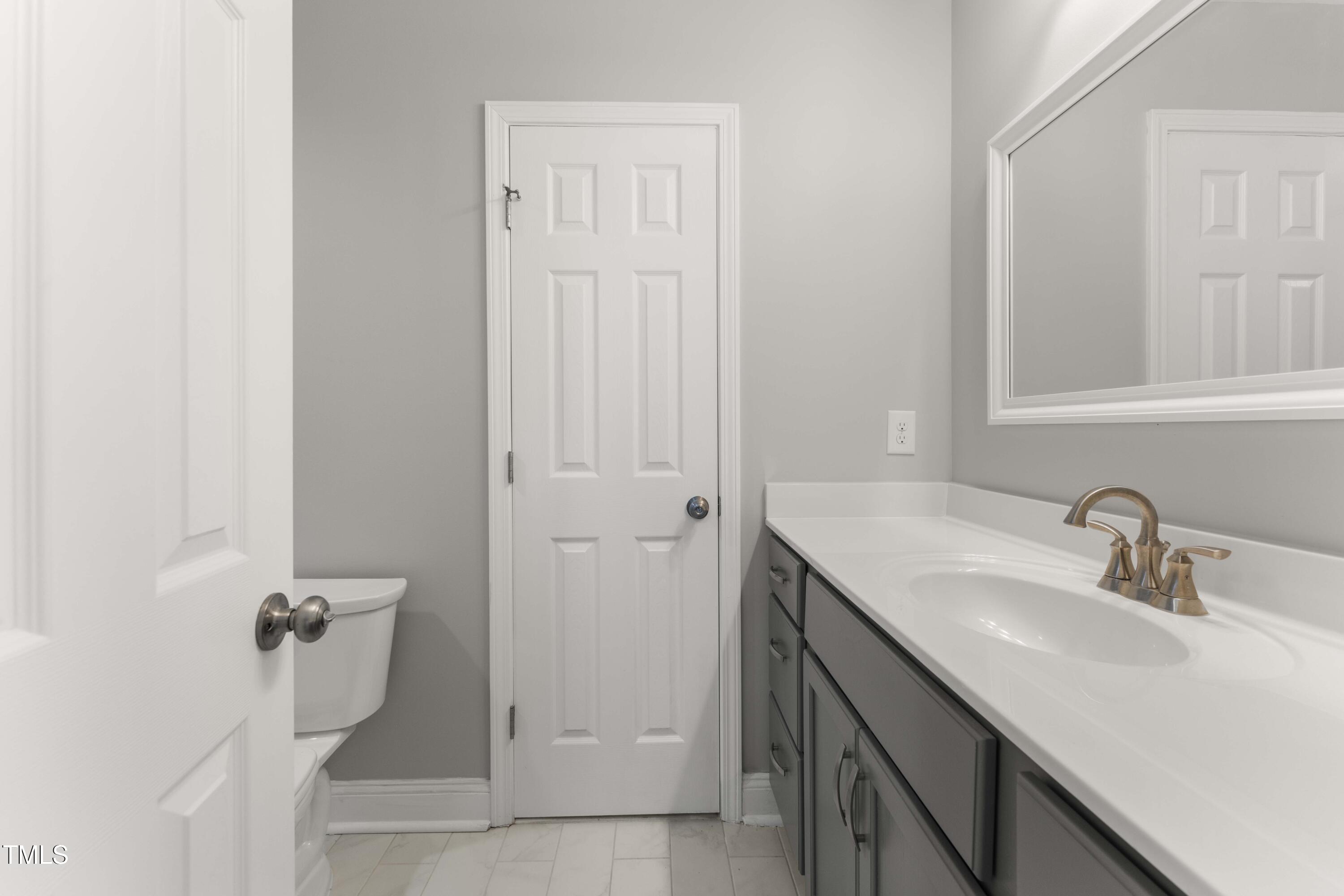 1426 Quarter Point Raleigh, NC 27615 - Photo 42 of 64 a bathroom with a sink and mirror