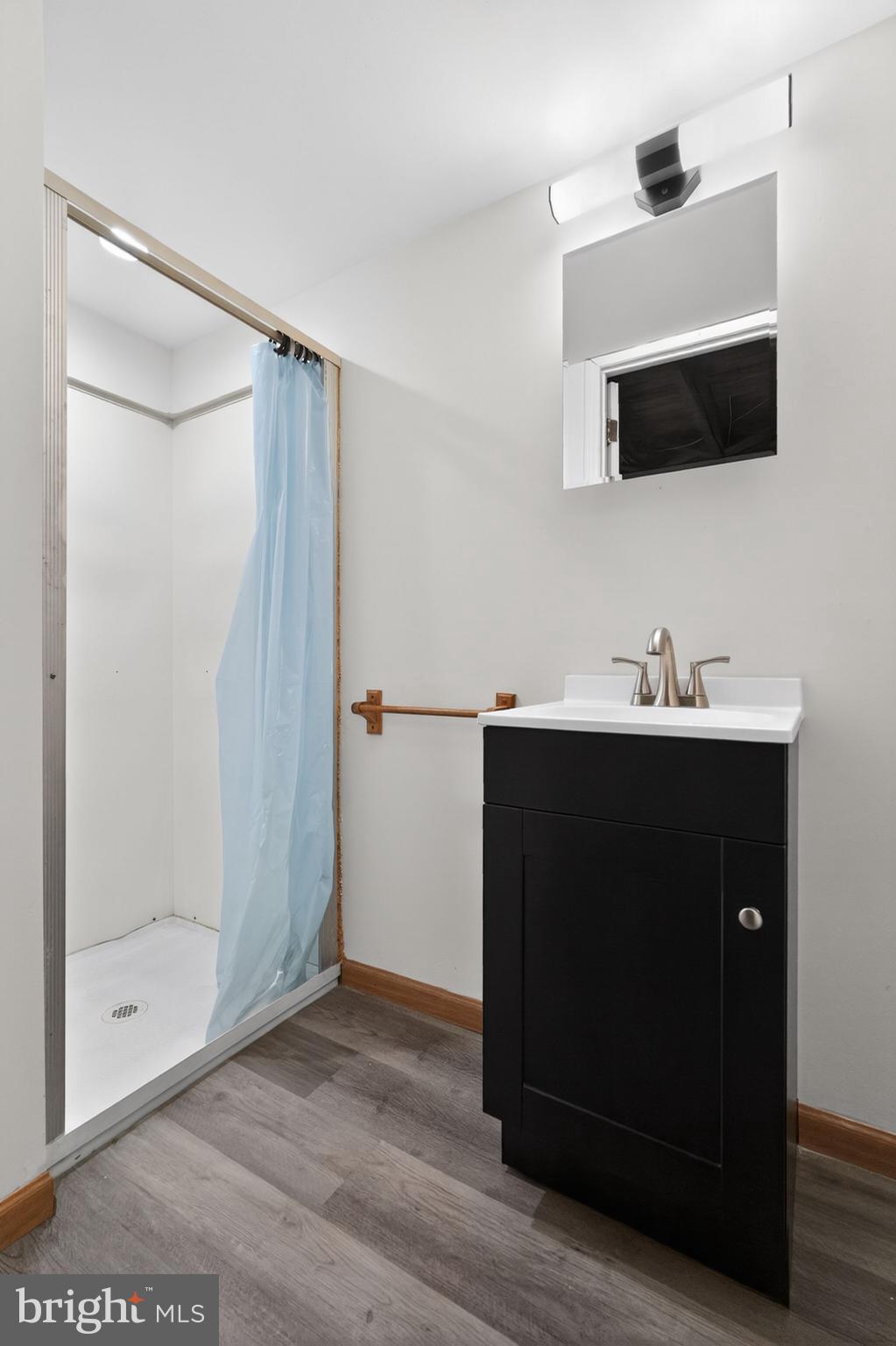 1311 Spring Street Sharon Hill, PA 19079 - Photo 15 of 21 a bathroom with a sink a mirror and a shower