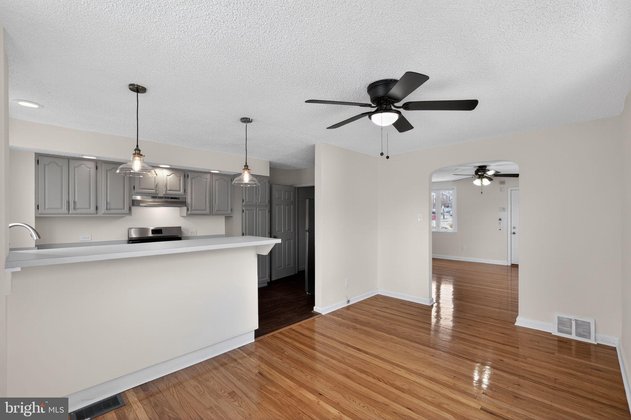 1311 Spring Street Sharon Hill, PA 19079 - Photo 5 of 21 a kitchen with kitchen island white cabinets and wooden floor