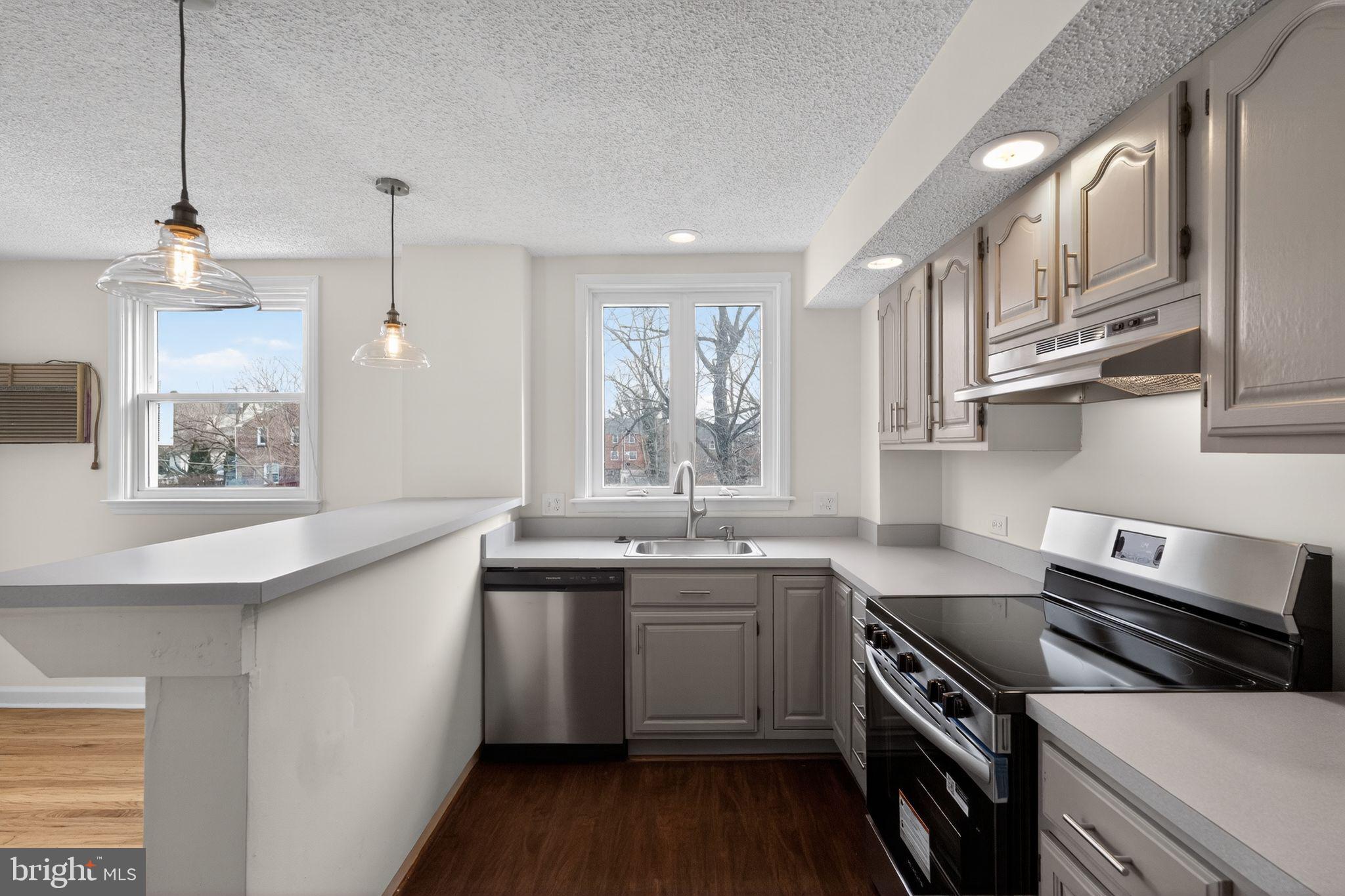 1311 Spring Street Sharon Hill, PA 19079 - Photo 6 of 21 a kitchen with stainless steel appliances a sink stove and cabinets