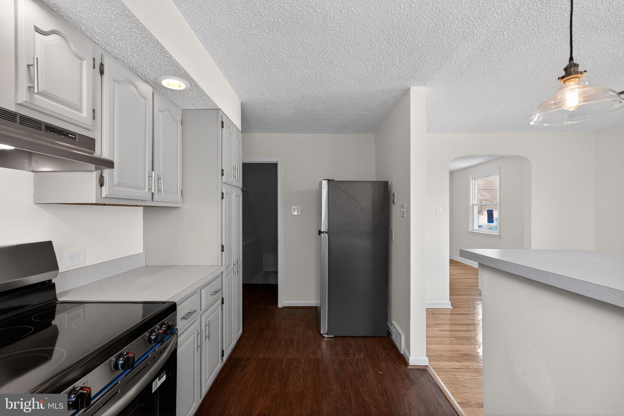 1311 Spring Street Sharon Hill, PA 19079 - Photo 7 of 21 a kitchen with stainless steel appliances a refrigerator and a stove top oven