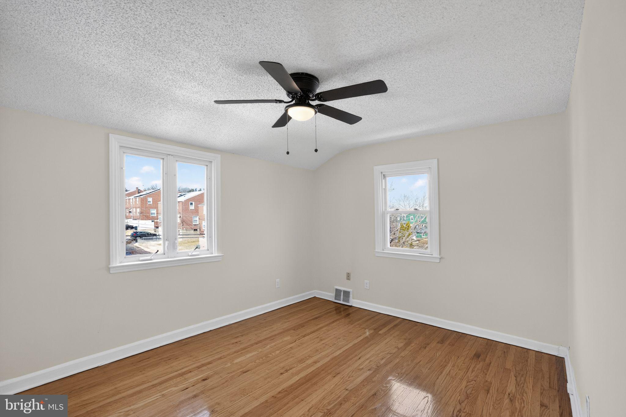 1311 Spring Street Sharon Hill, PA 19079 - Photo 9 of 21 a view of an empty room with wooden floor and a window