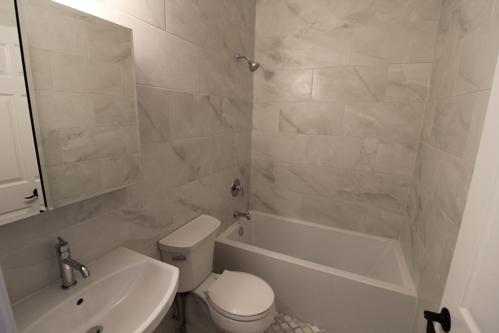 2054 West Division Street, Unit 3 Chicago, IL 60622 - Photo 12 of 15 a white toilet and tub sitting next to a bathroom sink