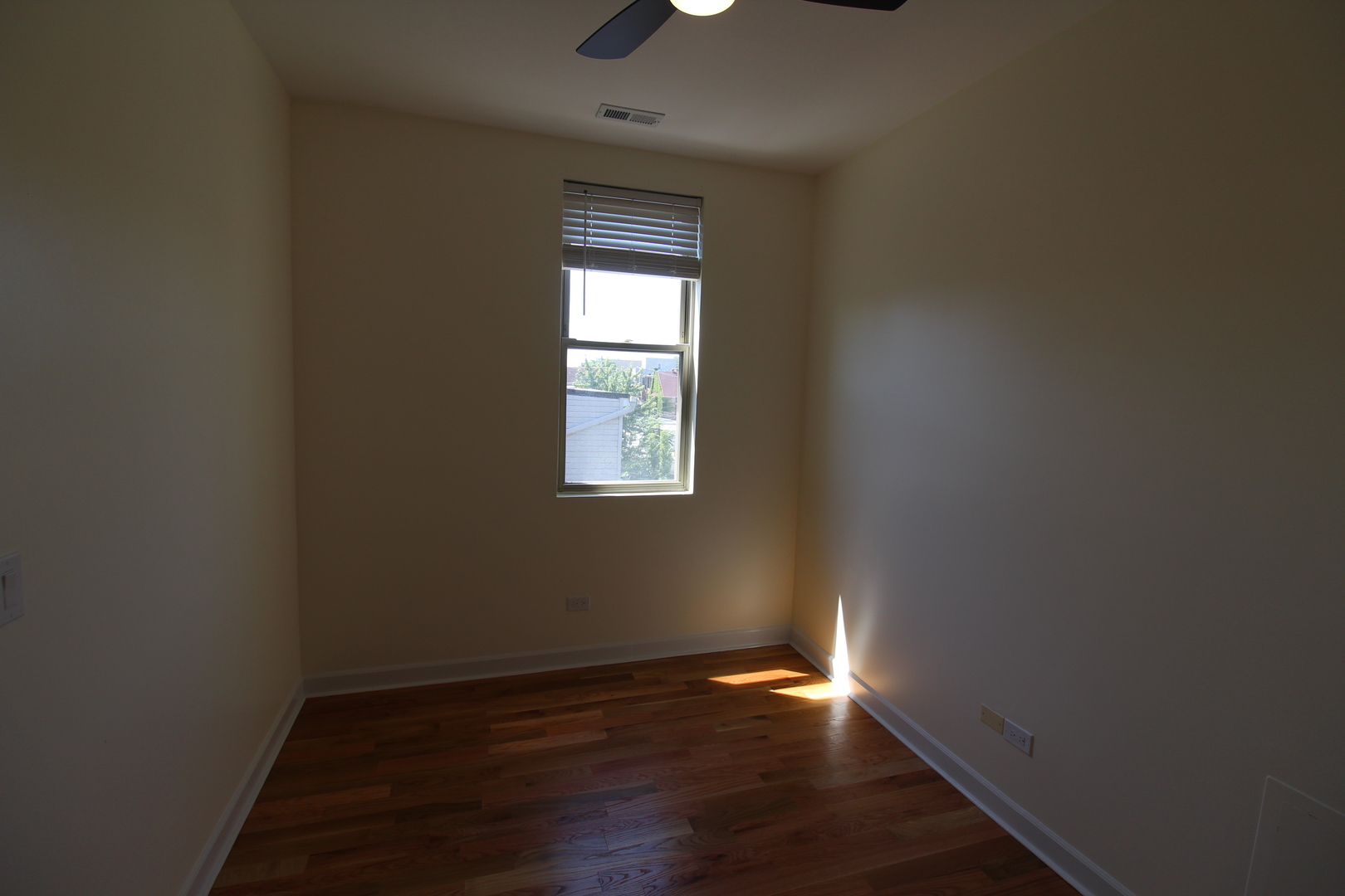 2054 West Division Street, Unit 3 Chicago, IL 60622 - Photo 13 of 15 a view of an empty room with wooden floor and a window