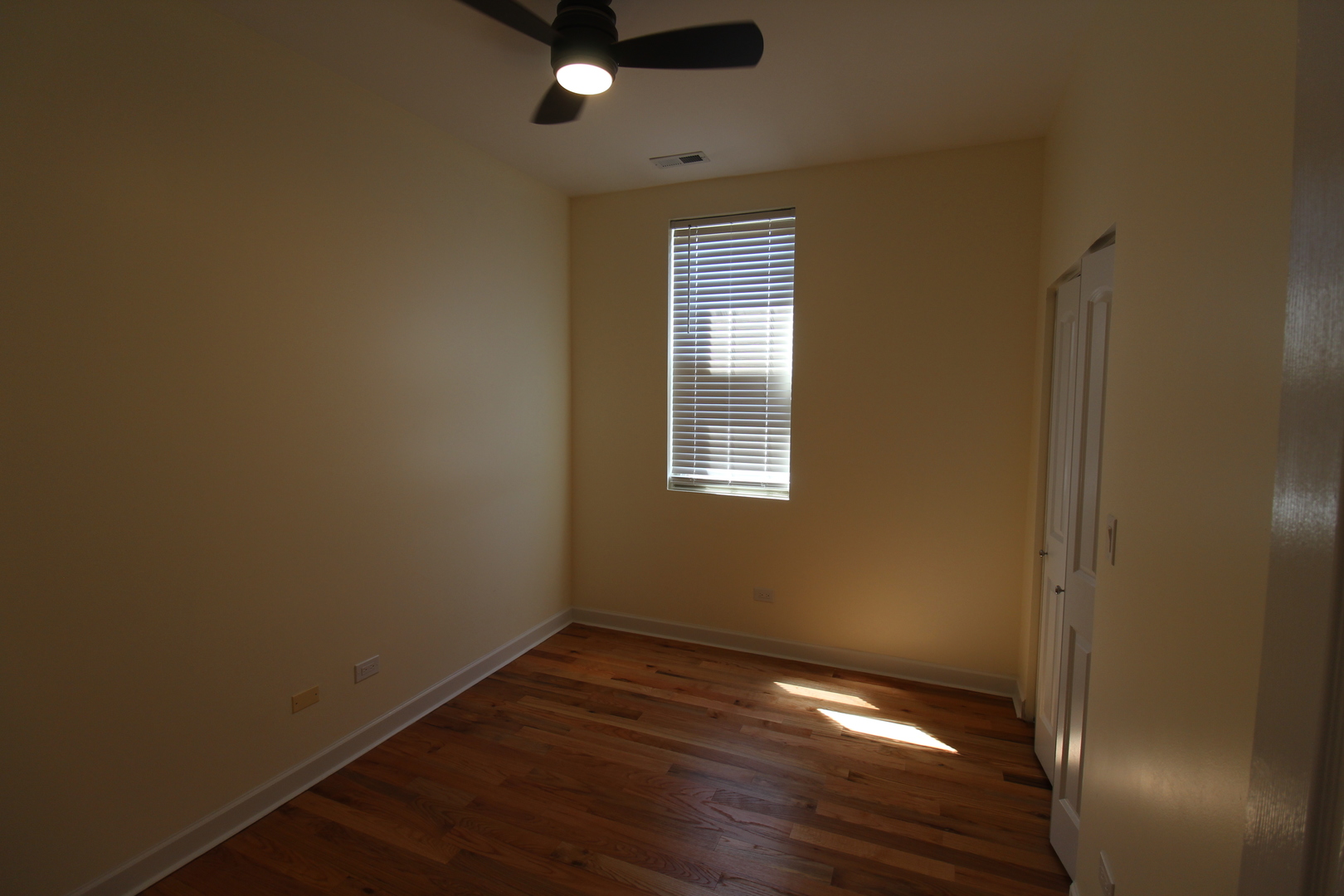 2054 West Division Street, Unit 3 Chicago, IL 60622 - Photo 14 of 15 a view of an empty room with wooden floor and a window