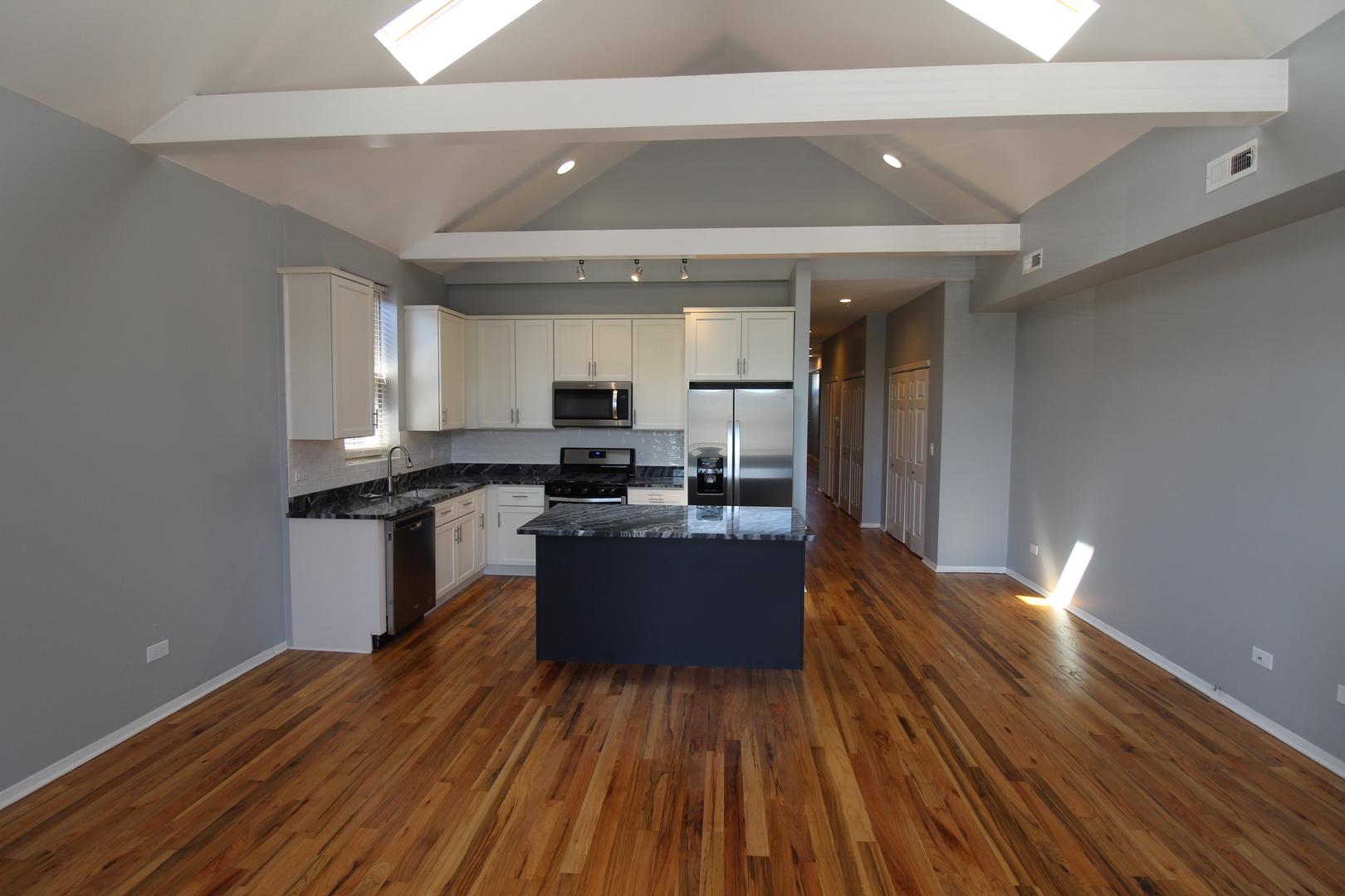 2054 West Division Street, Unit 3 Chicago, IL 60622 - Photo 2 of 15 a kitchen with a refrigerator and wooden floor