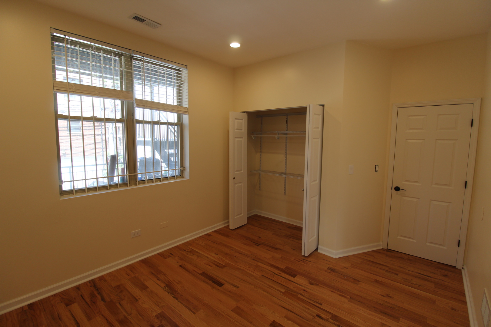 2054 West Division Street, Unit 3 Chicago, IL 60622 - Photo 7 of 15 a view of an empty room with wooden floor and a window
