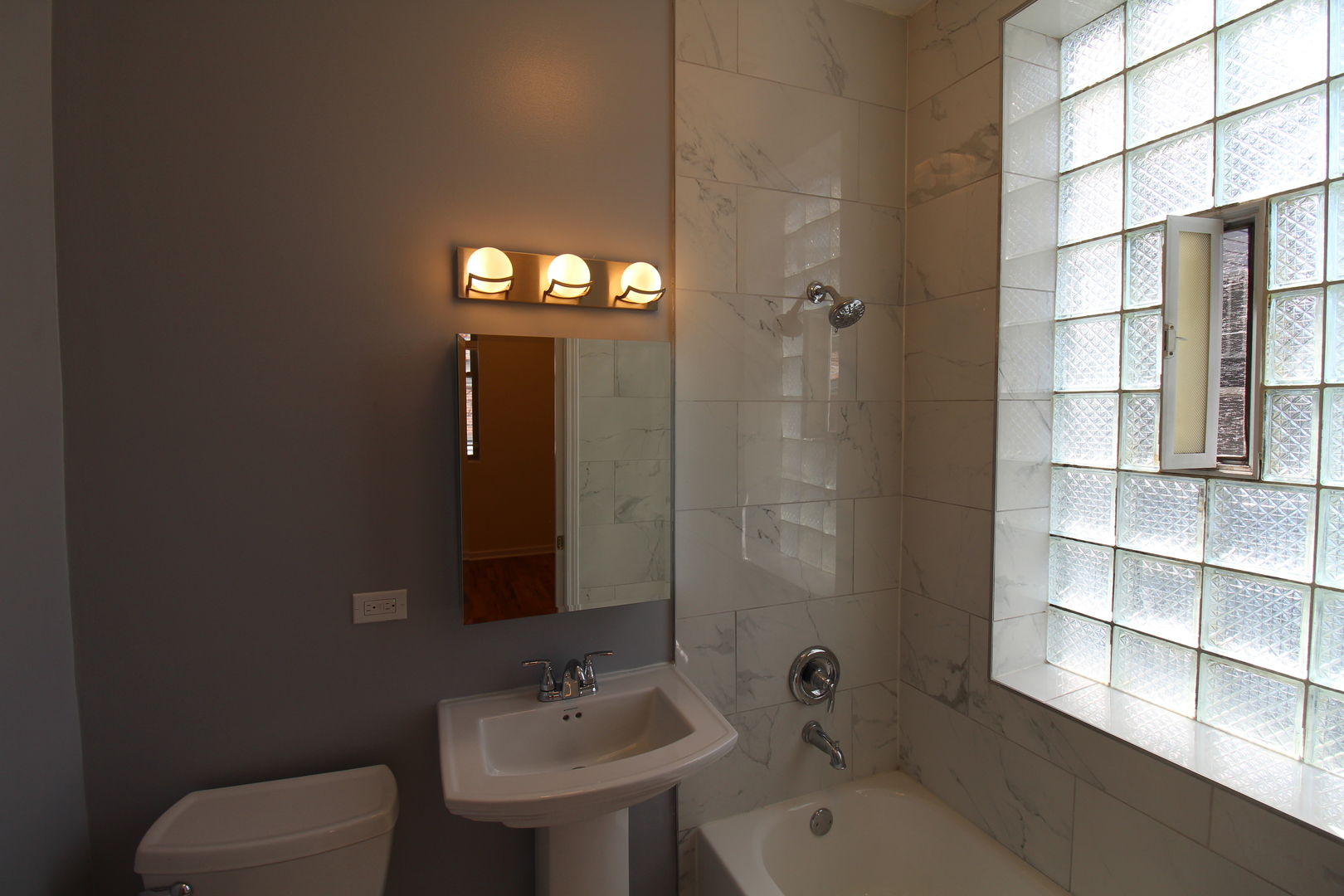 2054 West Division Street, Unit 3 Chicago, IL 60622 - Photo 8 of 15 a bathroom with a sink and a mirror