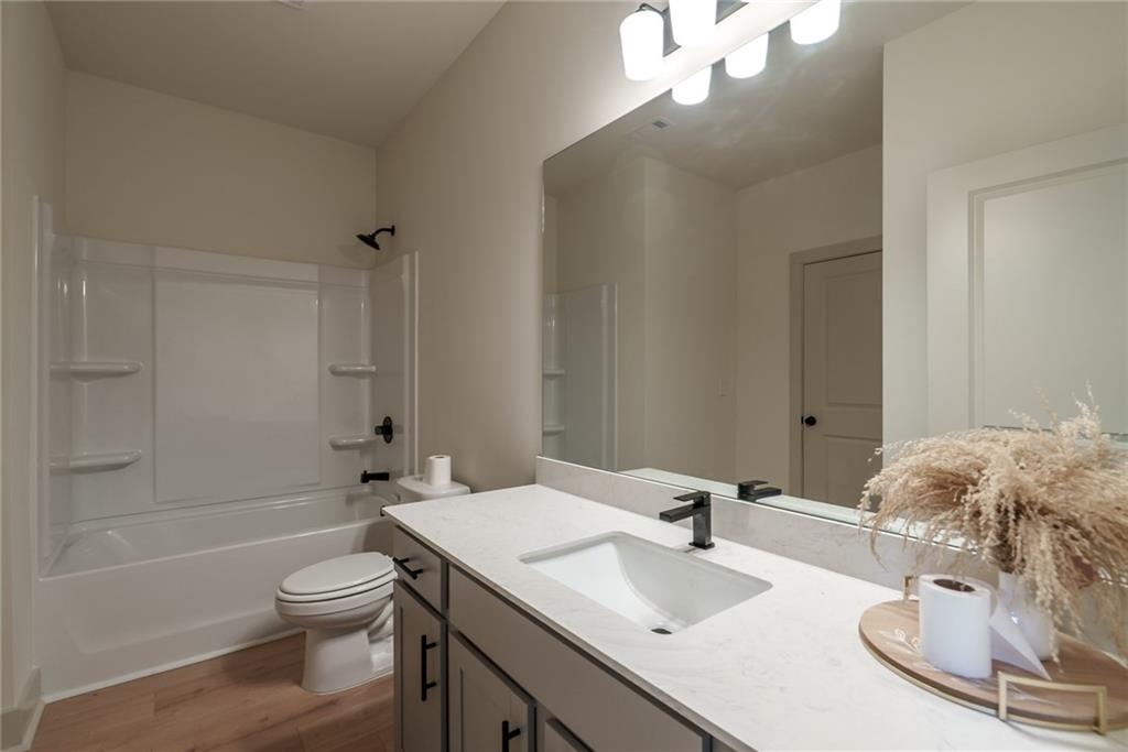 222 Good Hope Preserve Good Hope, GA 30641 - Photo 11 of 46 a bathroom with a granite countertop sink a toilet and bathtub