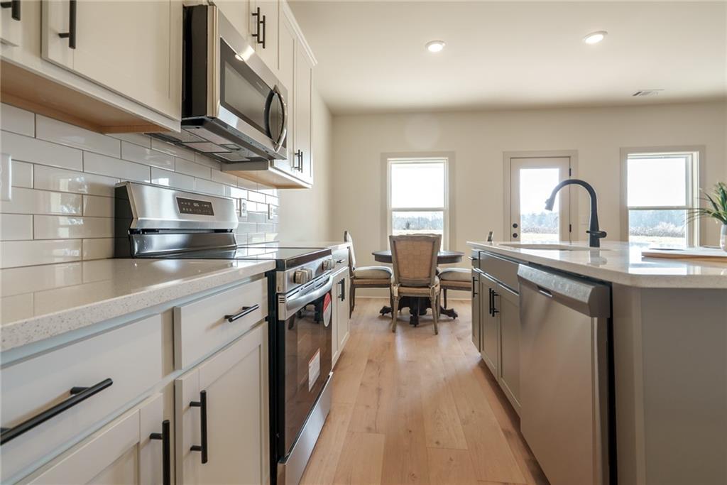 222 Good Hope Preserve Good Hope, GA 30641 - Photo 20 of 63 a kitchen with stainless steel appliances granite countertop a lot of counter space