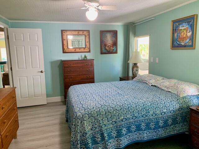 918 South Ruby Drive Key Largo, FL 33037 - Photo 31 of 57 a bedroom with a bed and a dresser