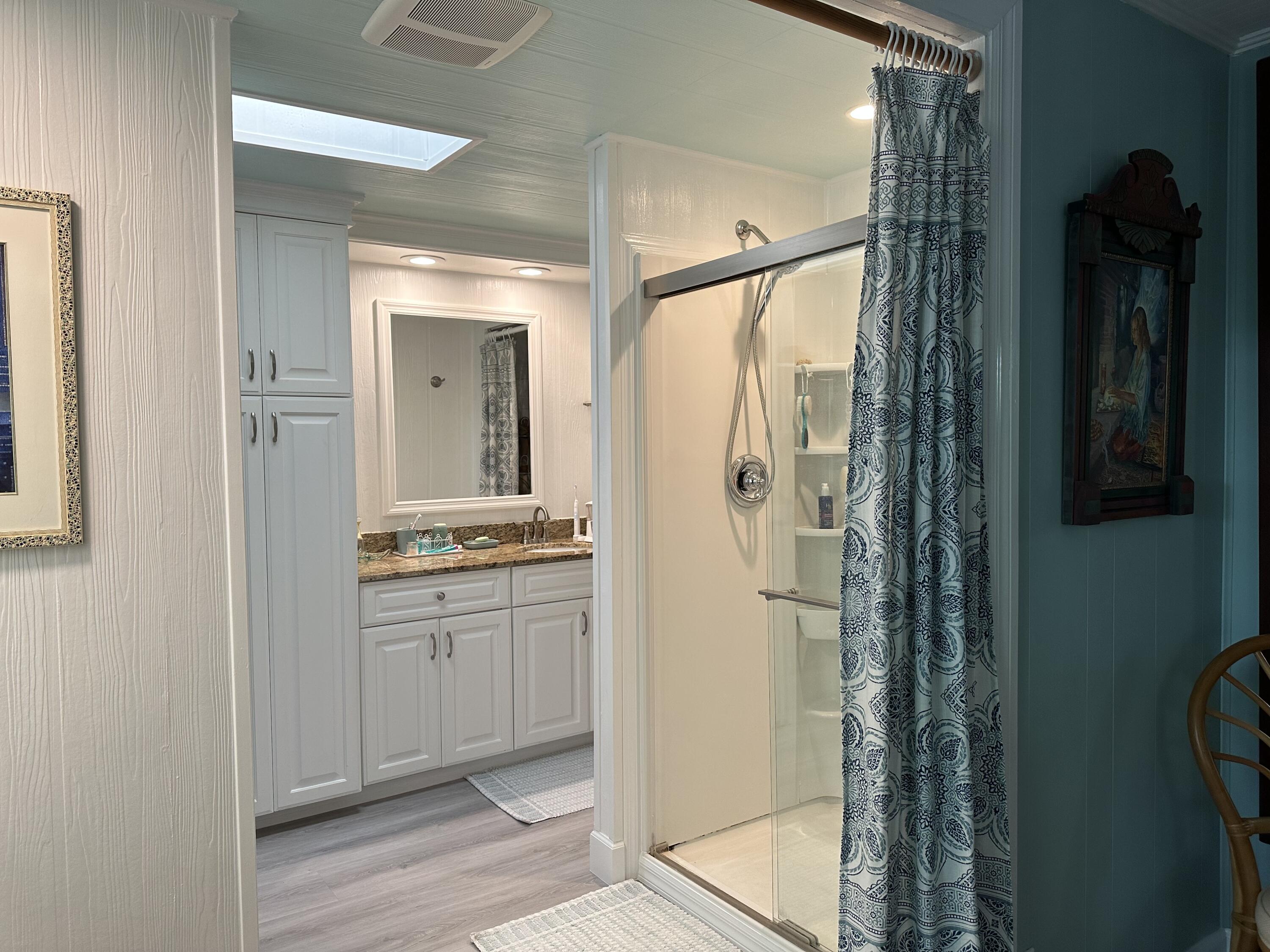 918 South Ruby Drive Key Largo, FL 33037 - Photo 32 of 57 a bathroom with a granite countertop shower a mirror and a sink