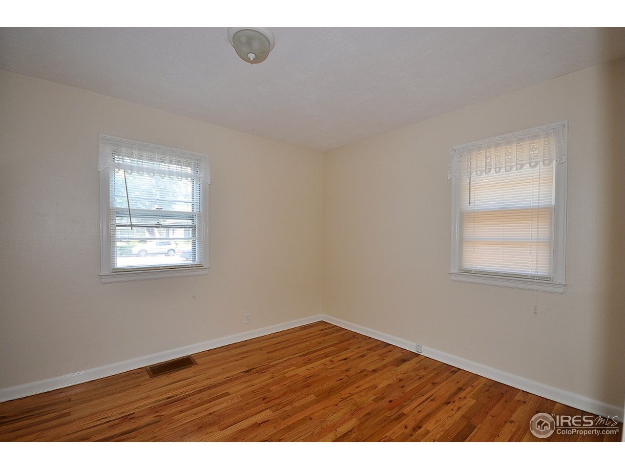 222 North Whitcomb Street Fort Collins, CO 80521 - Photo 15 of 23 an empty room with wooden floor and windows