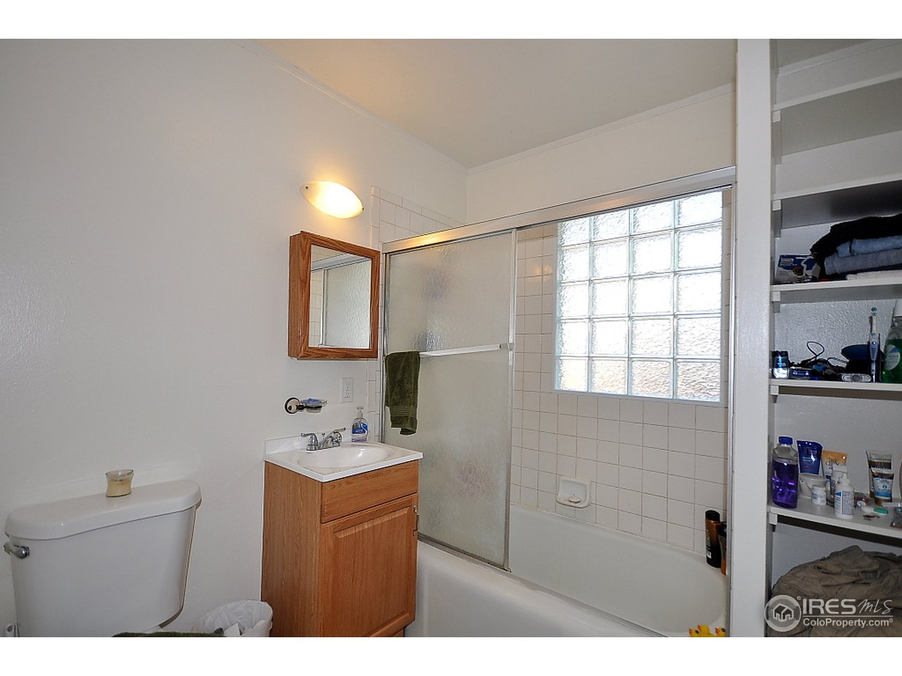 222 North Whitcomb Street Fort Collins, CO 80521 - Photo 17 of 23 a bathroom with a sink a mirror and a shower