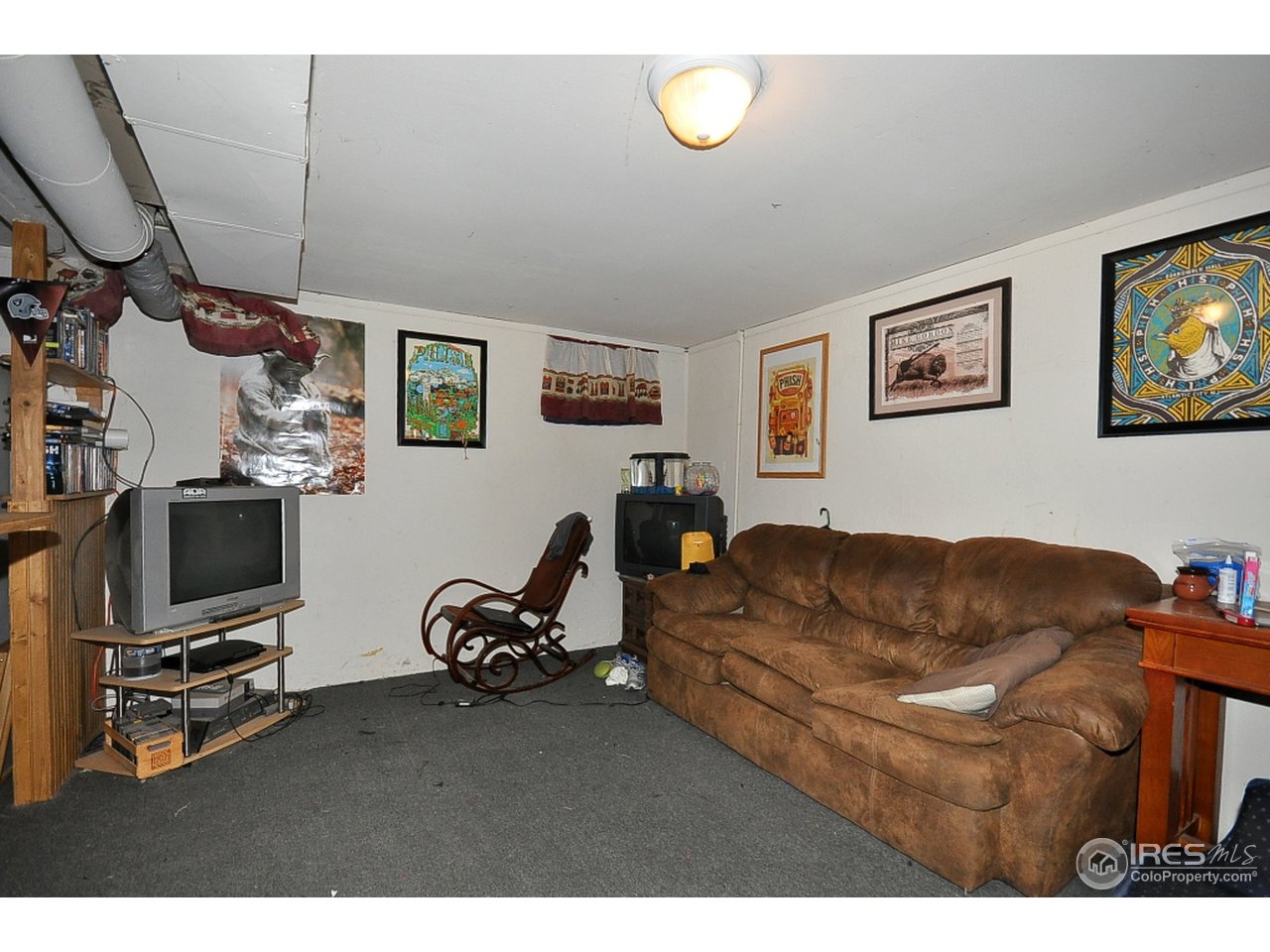 222 North Whitcomb Street Fort Collins, CO 80521 - Photo 19 of 23 a living room with furniture and a flat screen tv