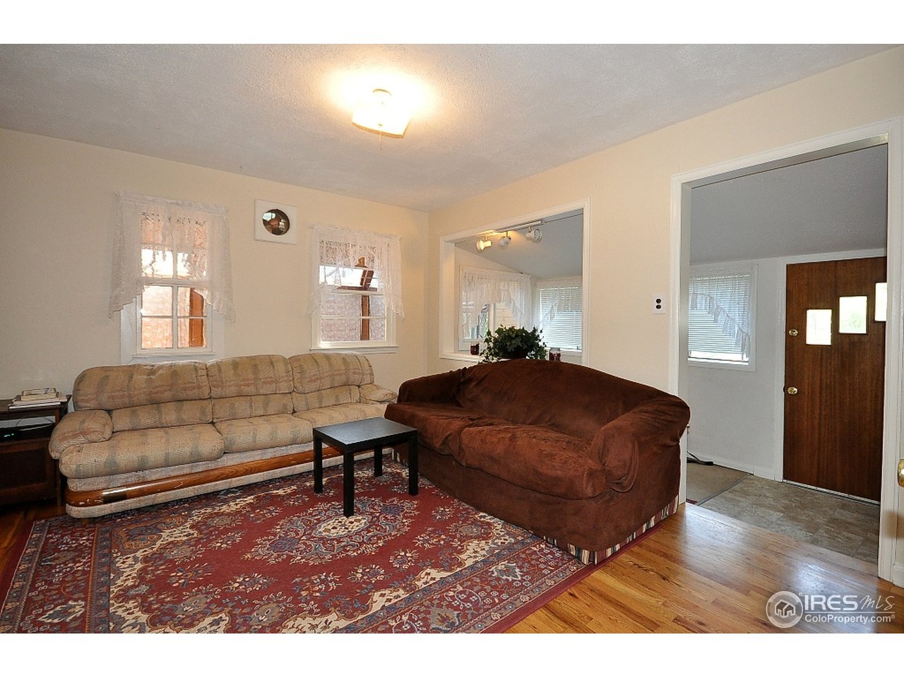 222 North Whitcomb Street Fort Collins, CO 80521 - Photo 2 of 23 a living room with furniture and a wooden floor