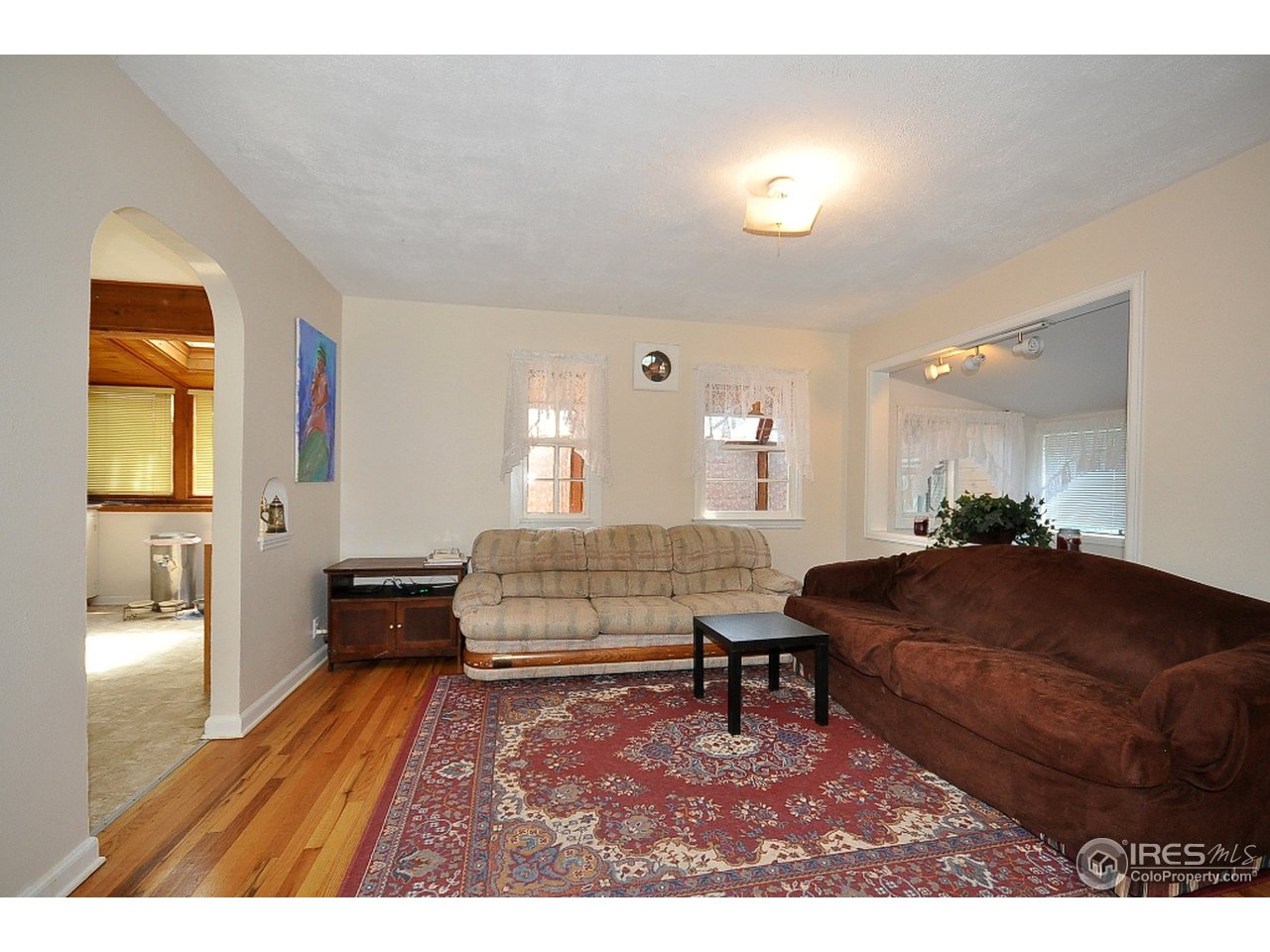 222 North Whitcomb Street Fort Collins, CO 80521 - Photo 3 of 23 a living room with furniture and a wooden floor