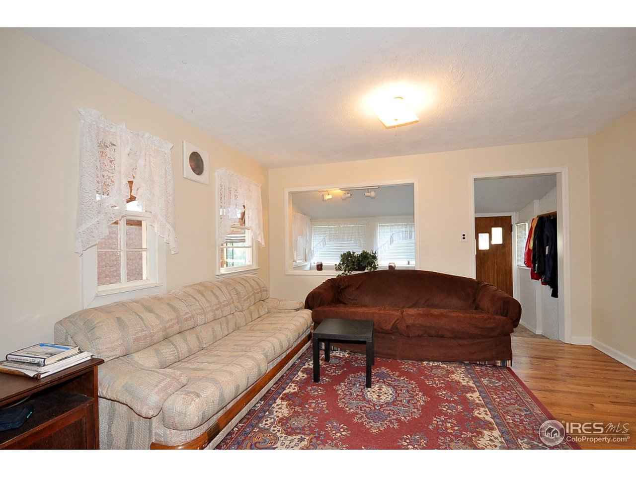 222 North Whitcomb Street Fort Collins, CO 80521 - Photo 5 of 23 a living room with furniture a rug and a chandelier