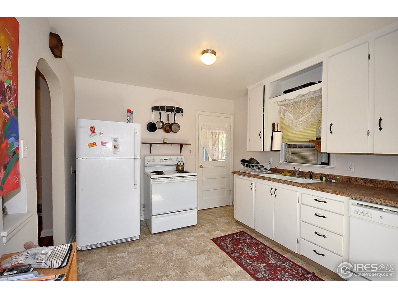 222 North Whitcomb Street Fort Collins, CO 80521 - Photo 7 of 23 a kitchen with sink cabinets and refrigerator