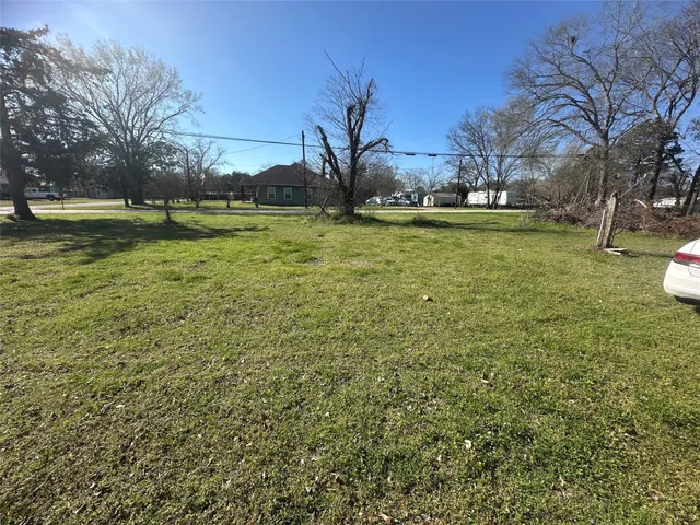 a view of outdoor space with green field and trees
