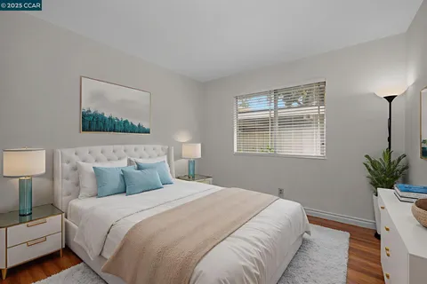 a bedroom with a bed and a potted plant