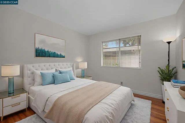 a bedroom with a bed and a potted plant
