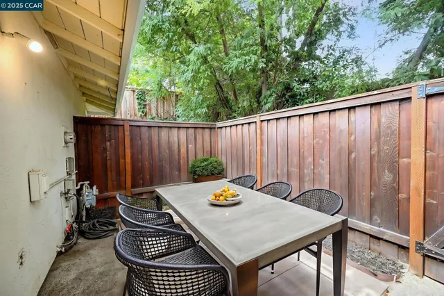 a backyard of a house with table and chairs