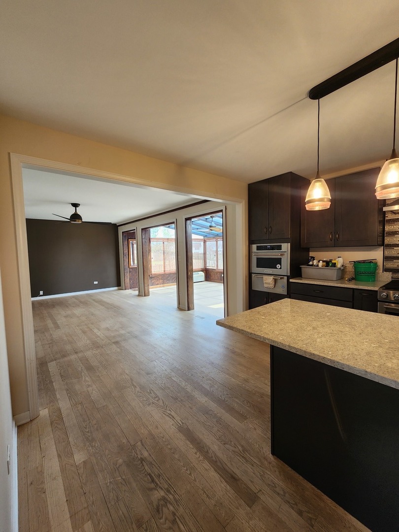7309 Atkinson Circle Plainfield, IL 60586 - Photo 11 of 38 a view of kitchen with cabinets and wooden floor