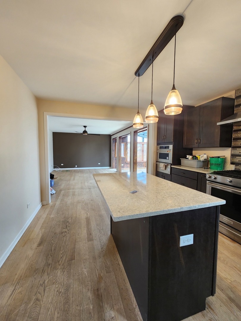 7309 Atkinson Circle Plainfield, IL 60586 - Photo 12 of 38 a large kitchen with stainless steel appliances kitchen island a large island in the center