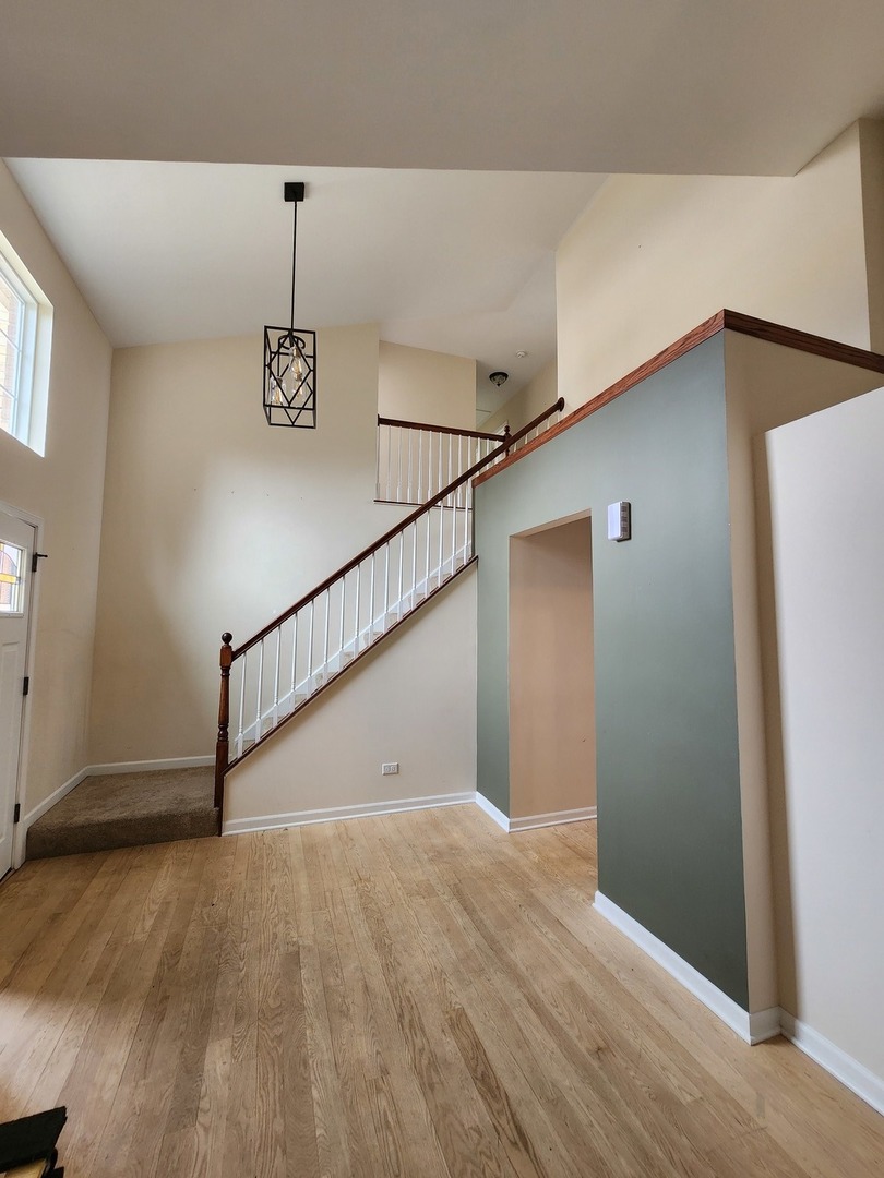 7309 Atkinson Circle Plainfield, IL 60586 - Photo 13 of 38 a view of a hallway with wooden floor
