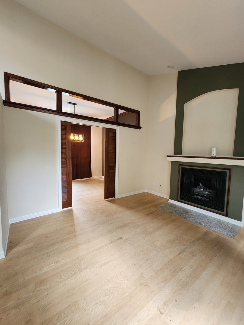 7309 Atkinson Circle Plainfield, IL 60586 - Photo 14 of 38 a view of an empty room with a fireplace and a fan