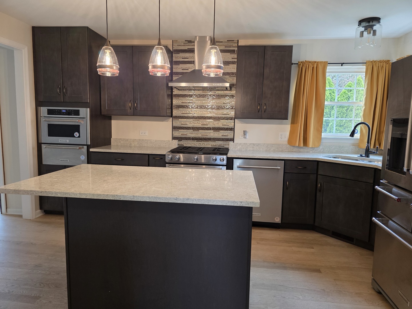 7309 Atkinson Circle Plainfield, IL 60586 - Photo 30 of 38 a kitchen with kitchen island granite countertop a sink a counter top space stainless steel appliances and cabinets