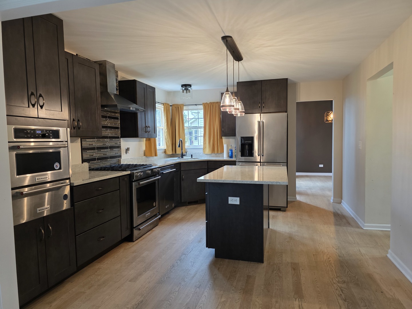 7309 Atkinson Circle Plainfield, IL 60586 - Photo 35 of 38 a large kitchen with stainless steel appliances wooden cabinets and a refrigerator