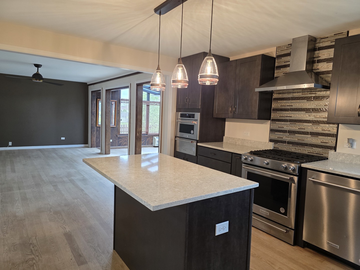 7309 Atkinson Circle Plainfield, IL 60586 - Photo 4 of 38 a kitchen with stainless steel appliances granite countertop a sink a stove and a refrigerator