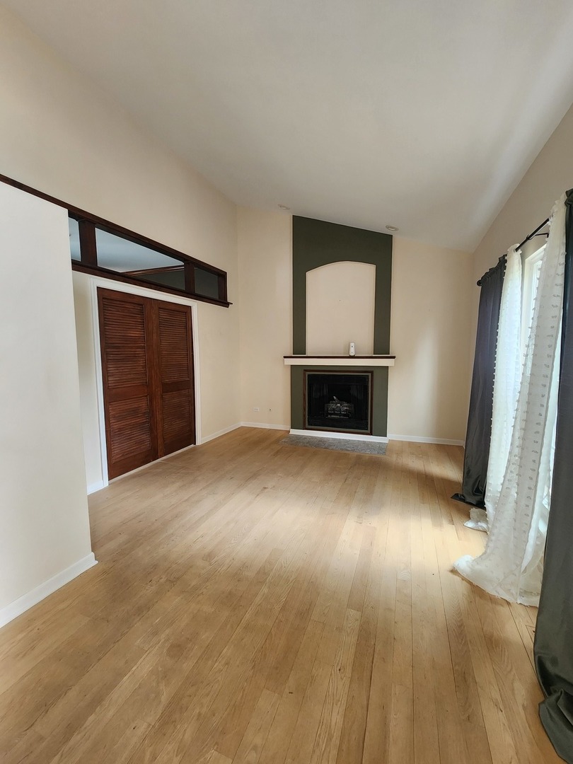 7309 Atkinson Circle Plainfield, IL 60586 - Photo 10 of 38 a view of empty room with wooden floor and window